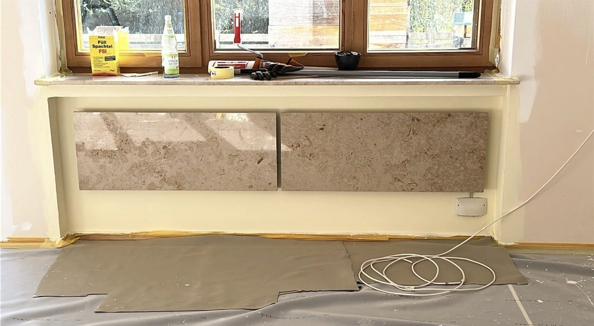 Twee Marwona Jura marmeren verwarmingspanelen naast elkaar in een raamnis, geïnstalleerd door Michael Schreistetter - foto genomen tijdens de bouwfase